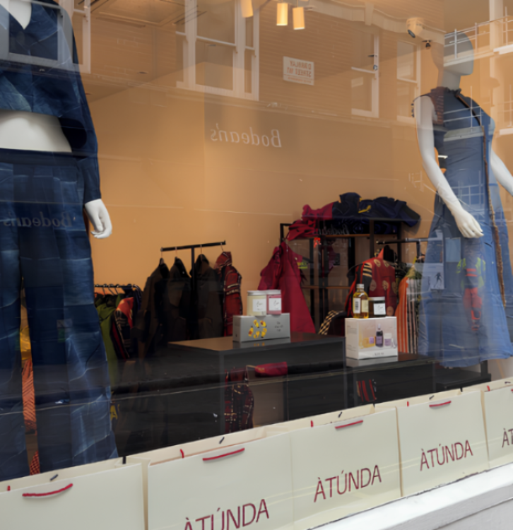 Storefront with mannequins wearing jeans and 'ATUNDA' branding.